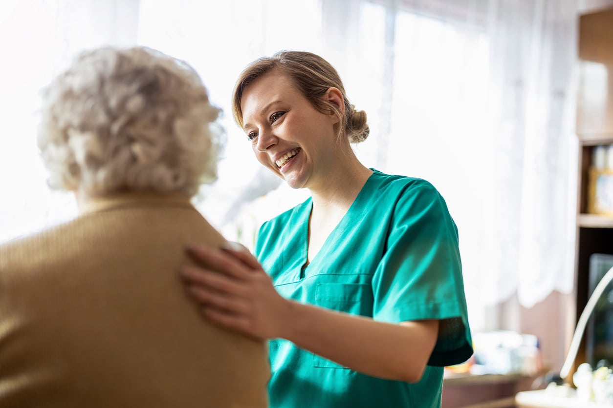 Caregiver at the Memory Care & Assisted Living Community in Ypsilanti Interacting With Senior